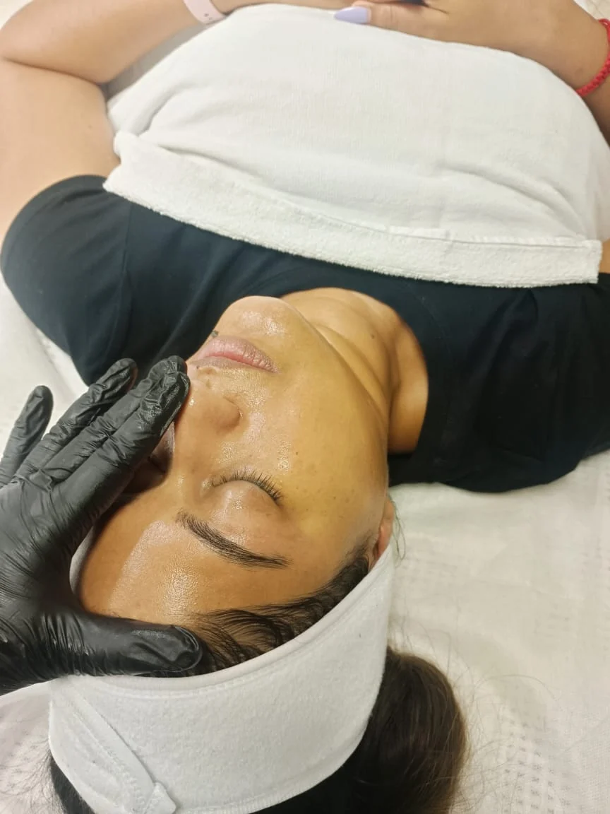A client receiving a facial at Waxbae