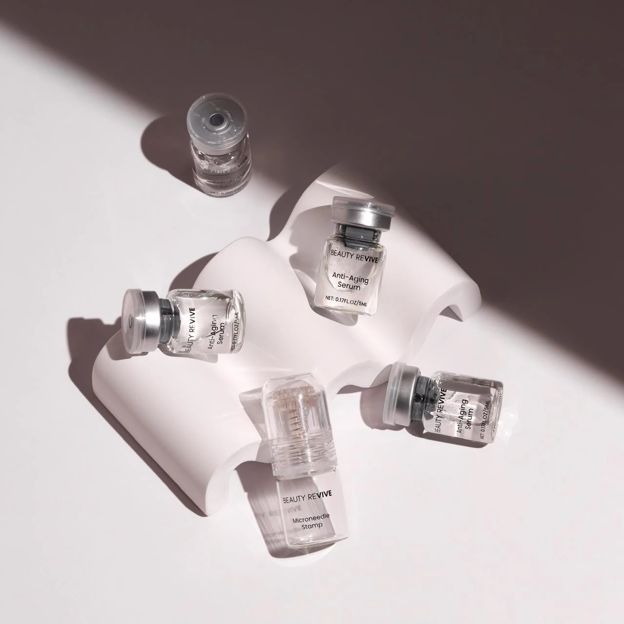 Facial serum vials and a treatment applicator